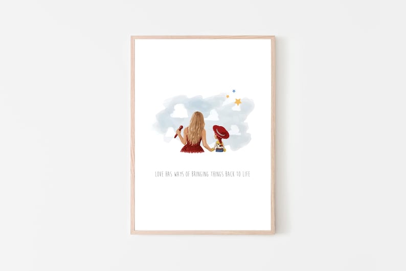 May include: A framed art print featuring a watercolor illustration of a person with long blonde hair in a red dress holding a doll with a red hat. Above them are blue clouds and yellow stars. The text reads, LOVE HAS WAYS OF BRINGING THINGS BACK TO LIFE.