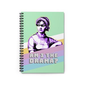 May include: Spiral-bound notebook featuring a pop art style illustration of a woman wearing pixelated sunglasses. The image is in shades of purple and white against a pastel background with the text "AM I THE DRAMA?"