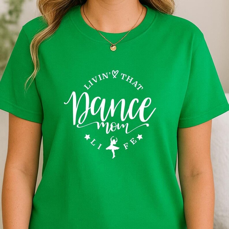 A woman wearing a green t-shirt with white text and a graphic design.