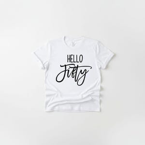 A white t-shirt with the text "HELLO FIFTY" printed on it.