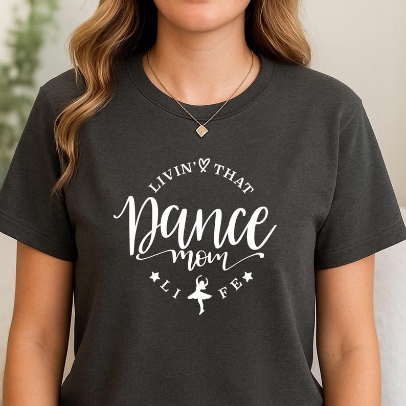 A woman wearing a black t-shirt with white text and a graphic design.
