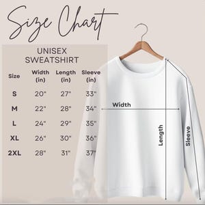 May include: A white unisex sweatshirt displayed on a wooden hanger. The image includes a size chart with measurements in inches for width, length, and sleeve length, ranging from size S to 2XL. The text "Size Chart" is at the top.