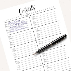 May include: A white contact list with the word "Contacts" in cursive at the top. The list has spaces for name, address, phone, and email. A black pen rests on the page, with the name, address, phone, and email of Olivia Martin filled in.