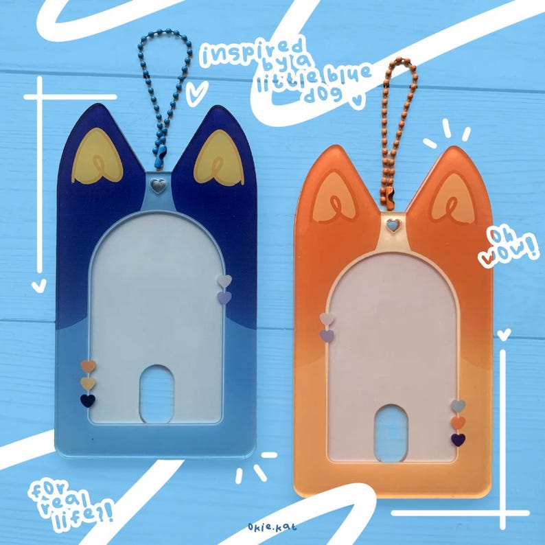 May include: Two colorful plastic card holders with a key chain loop. The blue card holder has a cat silhouette with the text "for real life!" and the orange card holder has a cat silhouette with the text "oh wow!"