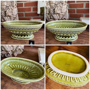 May include: Three green ceramic oval planters with a raised design. The bottom of one planter has the word "JAPAN" printed on it.