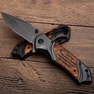 May include: A black and brown pocket knife with a wooden handle. The handle has the text "You're the best thing I've ever found on internet" engraved on it.
