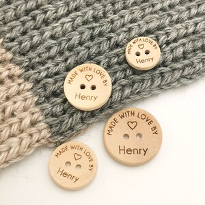 May include: Four wooden buttons with the text "Made with love by Henry" and a small heart engraved on each button.