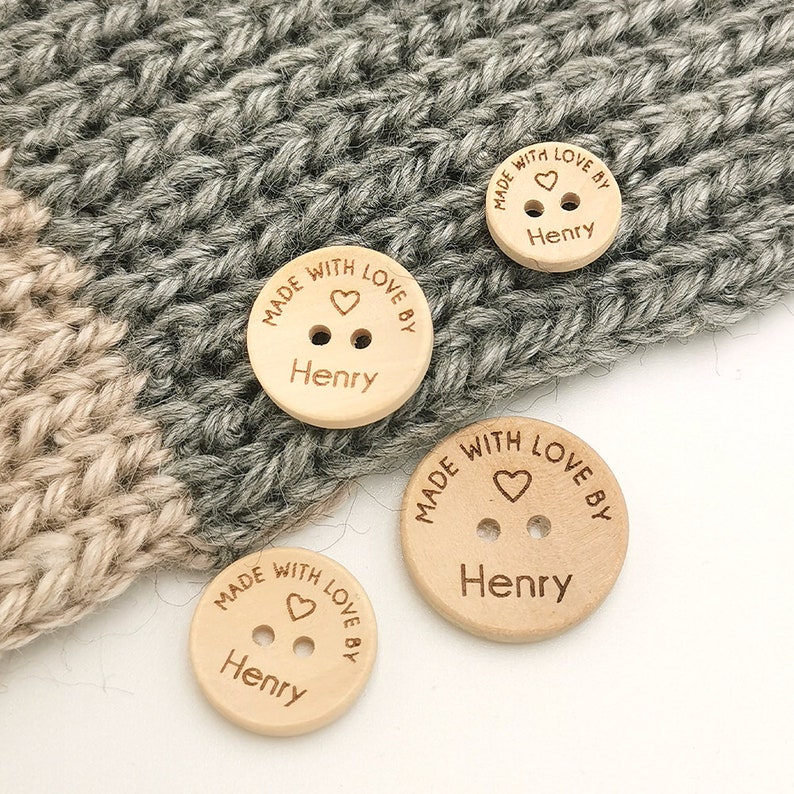May include: Four wooden buttons with the text "Made with love by Henry" and a small heart engraved on each button.