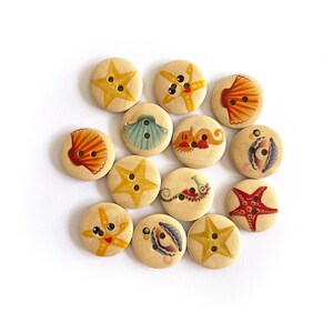 May include: A selection of wooden buttons decorated with marine life designs. The buttons showcase starfish, seashells, and other sea creatures in colours such as yellow, red, and blue. Each button has two or four holes for sewing.