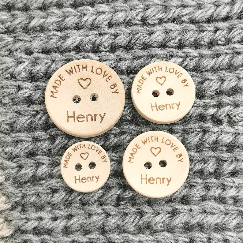 May include: Four wooden buttons with the text "MADE WITH LOVE BY Henry" and a small heart symbol engraved on each button.