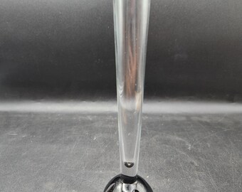 May include: A tall, clear glass vase with a black, bulbous base. The vase has a simple, elegant design.