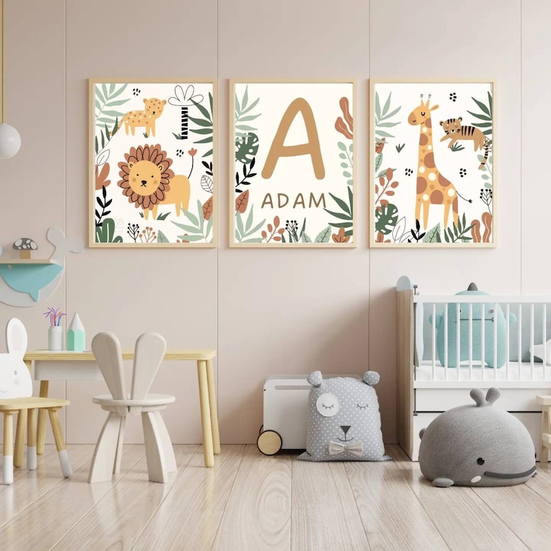 May include: Three framed prints with a jungle theme. The first print features a lion and a leopard. The second print features the letter A and the name Adam. The third print features a giraffe and a tiger.