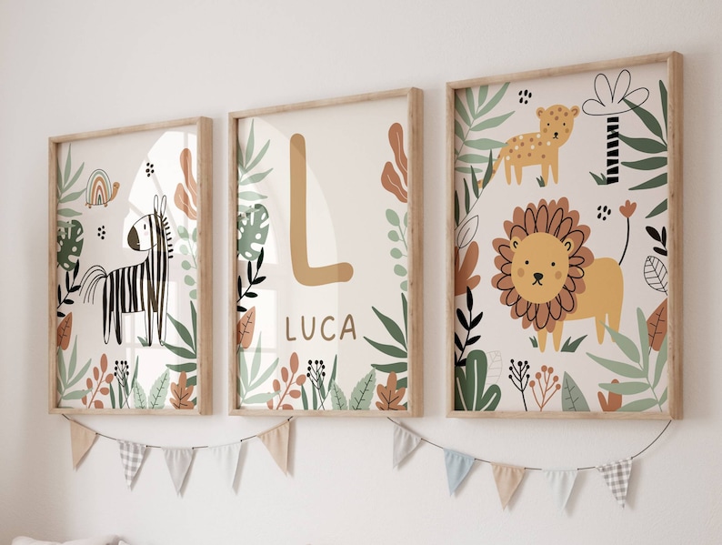 May include: Three framed prints with a jungle theme. The prints feature a zebra, a lion, and a letter L with the name Luca. The prints have a white background with green and brown foliage.
