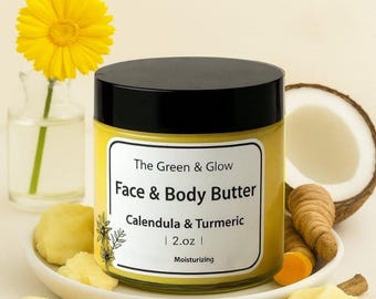 May include: A jar of Face & Body Butter with a black lid, labeled "Calendula & Turmeric" and "2.oz". The image includes a yellow flower, turmeric root, and a coconut half. The text indicates the product is moisturizing.