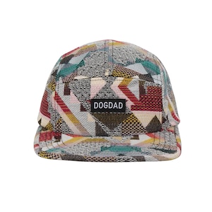 May include: A five-panel cap with a colorful geometric pattern in shades of red, yellow, green, and gray. The cap features a small rectangular patch with the word "DOGDAD" in white text.
