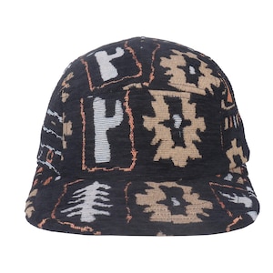 May include: A black baseball cap with a repeating pattern of beige, white, and orange geometric shapes. The cap has a curved brim and a structured crown, suitable for sun protection and casual wear.