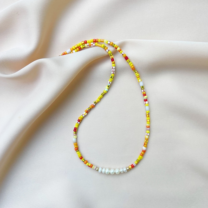 Long Beaded Necklace with Orange Beads and Shell Pendant