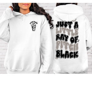 May include: White hoodie with a black and white graphic on the front that says "Pitch Black" and a coffin with a moon and bats. The back of the hoodie has a black and white graphic that says "Just a little ray of Pitch Black" with bats.
