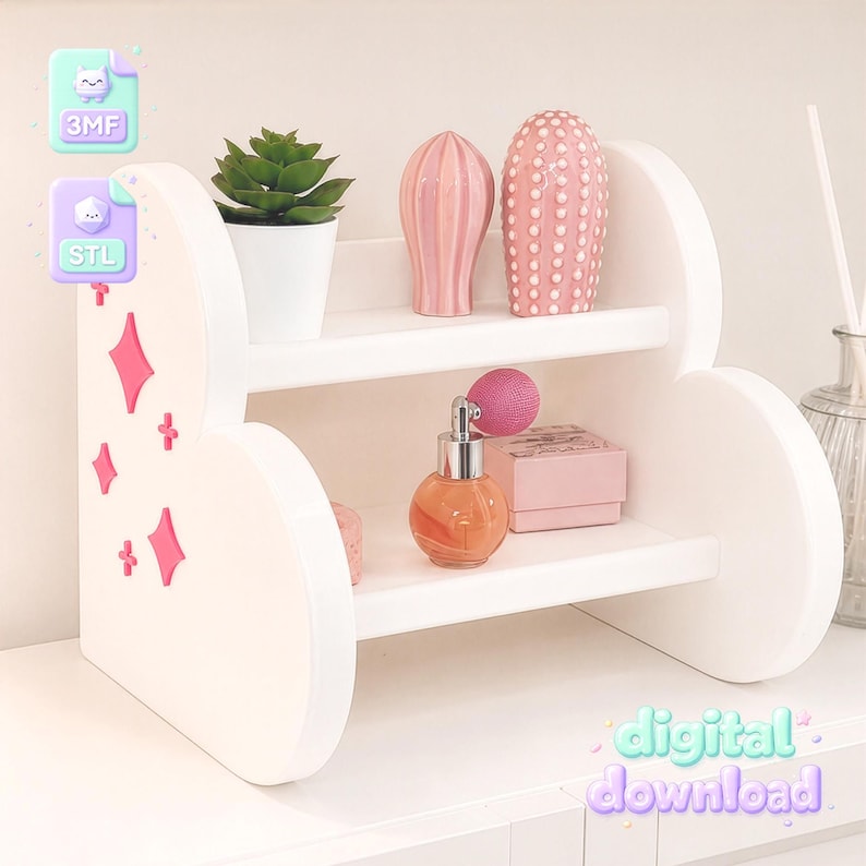 Pode incluir: Uma prateleira branca de dois n&iacute;veis com lados arredondados decorados com detalhes em forma de estrela rosa. A prateleira superior cont&eacute;m uma suculenta verde num vaso branco, um objeto rosa canelado e um objeto rosa texturizado.