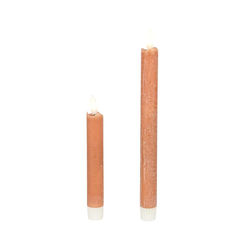 May include: Two brown taper candles with a white base and a flickering light at the top. One candle is shorter than the other. The candles are set against a white background.
