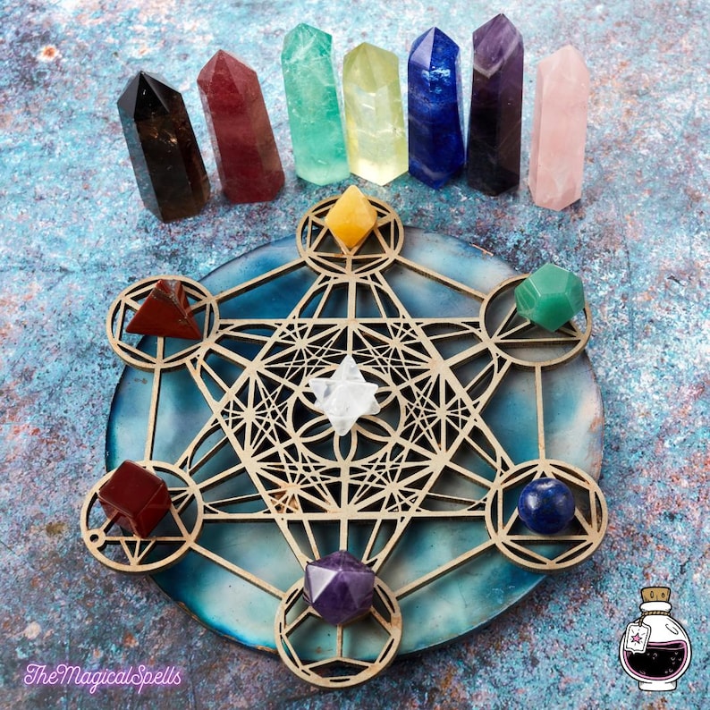 May include: A wooden geometric mandala with a crystal grid featuring seven chakra crystals in various colors, including clear quartz, amethyst, rose quartz, green aventurine, yellow citrine, blue lapis lazuli, and red carnelian.