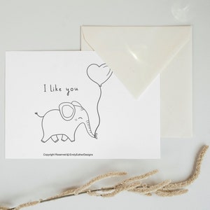 Greeting card with elephant on it holding a balloon