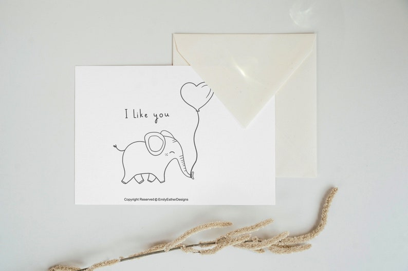 Greeting card with elephant on it holding a balloon