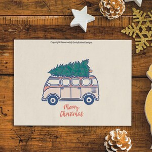 May include: A vintage-style, light blue and pink van with a Christmas tree on top. The van has a white body and blue trim. The text "Merry Christmas" is written in red and blue below the van.