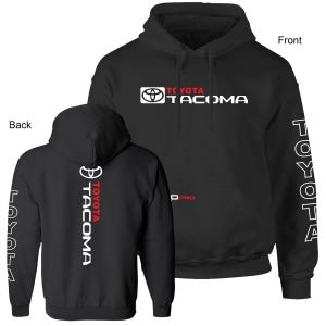 May include: Black hooded sweatshirt with the Toyota Tacoma logo in white and red on the front, back, and sleeves. The front features the logo and text "TOYOTA TACOMA". The back has a vertical logo and text. The sleeves have the word "TOYOTA" printed vertically.