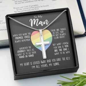 Pu&ograve; includere: Una collana d'argento con un ciondolo a forma di croce su uno sfondo nero. La croce &egrave; posizionata su un cuore arcobaleno. La collana viene fornita in una scatola con un messaggio che dice "To My Man" e "When you wear this promise cross always remember... Wherever the journey takes us, I want us to go there hand in hand. There are things in life that I'm not always clear about. But what I know for sure is you are the one I want to be with. My heart is locked away and you have the key. I'm all yours, my love."