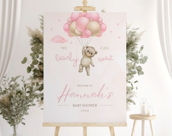 May include: Pink and gold baby shower welcome sign with a teddy bear holding balloons. The sign says "We barely can wait" and "Welcome to Hannah's Baby Shower 04.03.24".