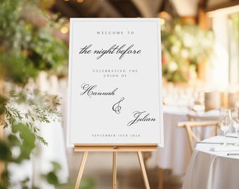 May include: A white wedding welcome sign on a wooden easel. The sign reads "WELCOME TO the night before CELEBRATING THE UNION OF Hannah & Julian SEPTEMBER 15TH 2024" in elegant script. The background shows a blurred wedding reception setting.