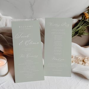 Puede incluir: Dos tarjetas verde claro con texto blanco. La tarjeta de la izquierda dice "Bienvenido a la boda de Jacob & Eleana" y enumera los detalles de la ceremonia. La tarjeta de la derecha dice "Wedding Party" y enumera los nombres de los miembros de la fiesta de bodas.
