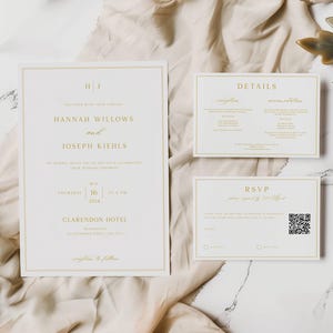 May include: A white wedding invitation suite with gold lettering. The invitation card features the names "Hannah Willows and Joseph Kiehls" and the date "May 16, 2024". The details card includes information about the ceremony and reception. The RSVP card has a QR code.