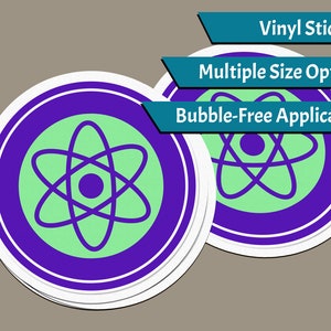 May include: Two round vinyl stickers with a purple border and a white outline. The stickers feature a green atom symbol on a light green background. The text "Vinyl Stickers", "Multiple Size Options", and "Bubble-Free Application" is visible above the stickers.