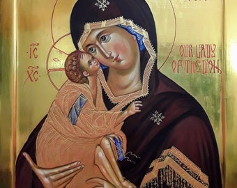 May include: A religious icon depicting the Virgin Mary holding the Christ Child. The artwork features a gold background and a dark maroon robe. The text "OUR LADY OF THE DON" is visible. The icon is framed in gold.