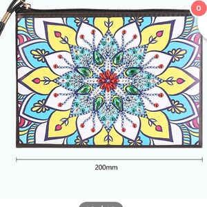 May include: A black clutch purse with a colorful mandala design. The purse measures 8 inches by 6 inches.
