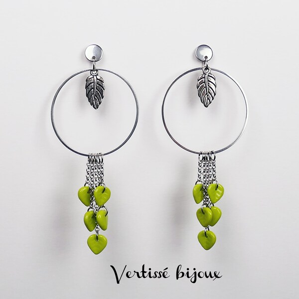 Stainless steel hoop earrings decorated with fringed chains, green leaf charms and silver metal leaf.