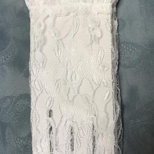 May include: A pair of white lace gloves with a floral pattern. The gloves are delicate and feminine.