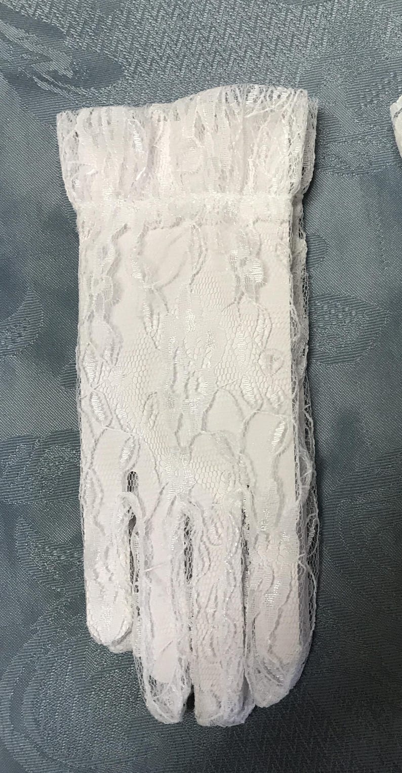 May include: A pair of white lace gloves with a floral pattern. The gloves are delicate and feminine.