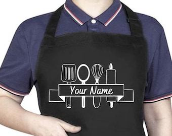May include: Black apron with a white design of kitchen utensils and a banner that says "Your Name".