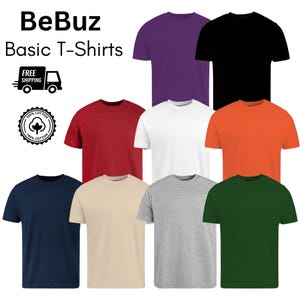 Puede incluir: Una colección de nueve camisetas básicas de color liso en varios colores, incluyendo morado, negro, rojo, blanco, naranja, azul marino, beige, gris y verde. La marca "BeBuz" y las palabras "Basic T-Shirts" se muestran en la parte superior. También se ve un logotipo de "100% Algodón".