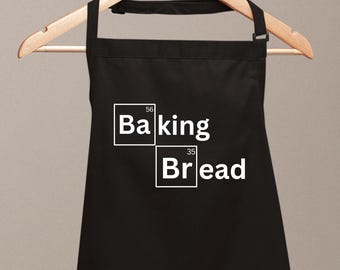 May include: Black apron with white text that reads "Baking Bread" in a periodic table style font.