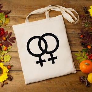 女性と金星のシンボルが描かれた LGBTQ プライド トートバッグ - 仲間やメンバーのためのスタイリッシュな LGBTQ アクセサリー!