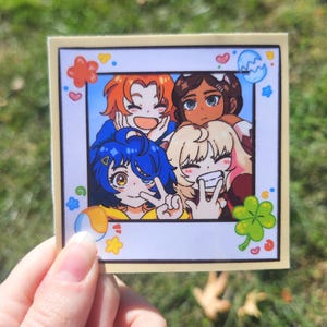 May include: A square sticker featuring a group of four anime-style characters posing for a photo. The characters have different hair colors and expressions. Decorative elements include hearts, clovers, and other shapes.
