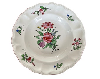 May include: White ceramic soup bowl with a red rim and a floral design featuring pink, red, yellow, blue, and green flowers.