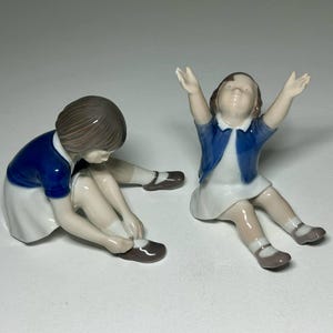 Set of 2 Bing and Grondahl Figurines #2317 Girl Buttoning her Shoe and #2324 &#39;Up to Mommy&#39;, Bing and Grøndahl Figurines by Svend Jespersen
