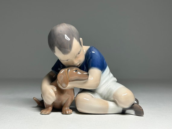 Royal Copenhagen Porcelain Figurine 'True Friendship' #1951, Royal Copenhagen Boy with Dog Figurine by Ingeborg Plockross Irminger