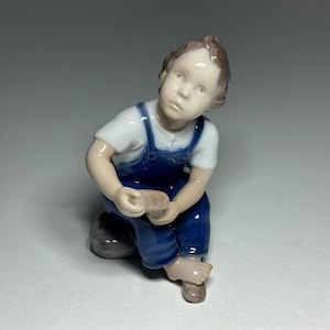 Bing and Grondahl Porcelain Figurine Boy with Shoe ‘Help Me, Mum’, Bing and Grøndahl Porcelain Figurine #2275 by Michaela Ahlmann