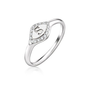 May include: A silver ring with a diamond-encrusted oval-shaped setting featuring the letter "S".